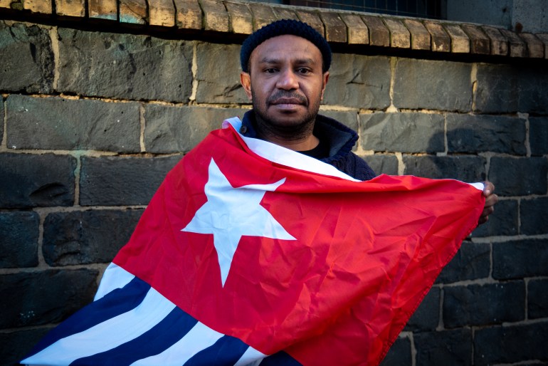 Adolf Mora wrapped in the Morning Star flag of West Papuan independence
