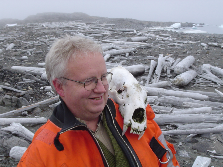 Ragnar Braekkan balances a polar bear skull on his shoulder during one of his summer voyages to maintain weather stations in remote northeastern Svalbard.