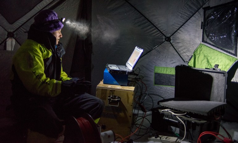 Zoe Koenig, a scientist with the University of Bergen, looks at data measuring temperature, salinity, and turbulence in the upper ocean during fieldwork in the Arctic.