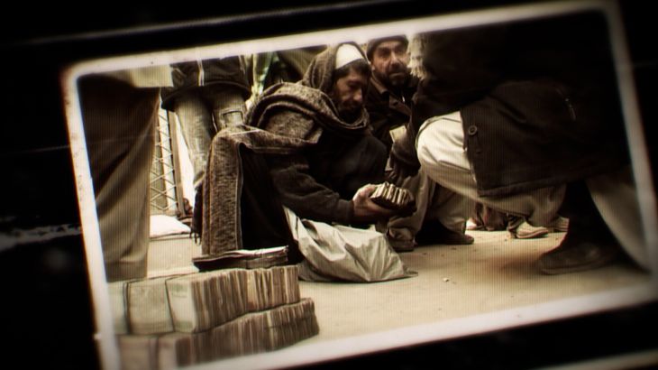 A photo of an Afghan man holding money
