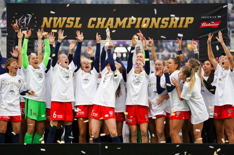 Players celebrate after winning the 2021 NWSL championship
