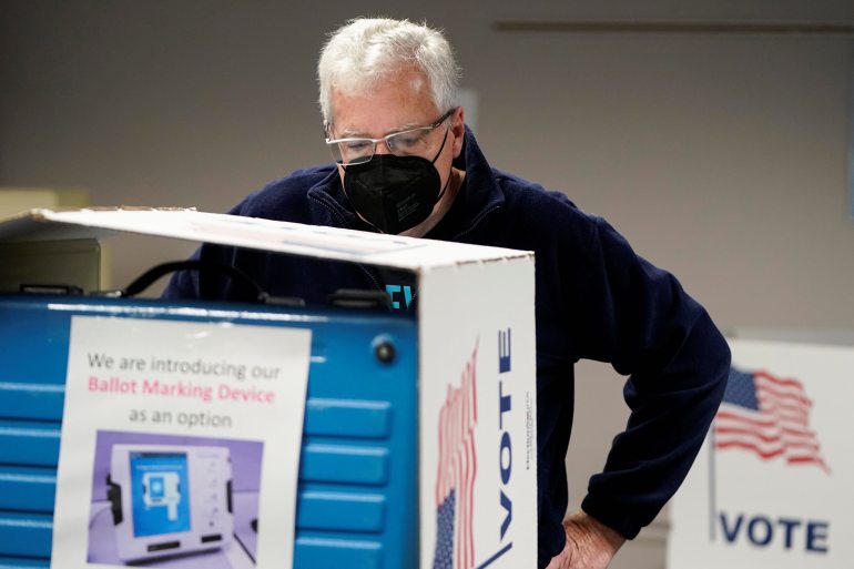 A man votes on the last day of early voting in the Virginia gubernatorial election in Fairfax, Virginia, U.S