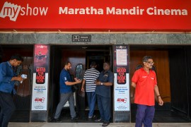 In this picture taken on September 30, 2022, people get their tickets checked before entering the Maratha Mandir Cinema Theatre in Mumbai. - India's Bollywood film industry, long part of the cultural fabric of the movie-mad country of 1.4 billion people, is facing its biggest-ever crisis as streaming services and non-Hindi language rivals steal its sparkle. (Photo by Punit PARANJPE / AFP) / To go with 'Entertainment-India-Cinema-Lifestyle-Film', FOCUS by Glenda KWEK