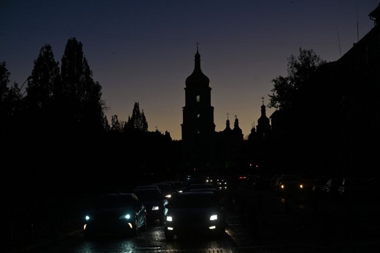Vehicles drive in dark due to a blackout in Kyiv