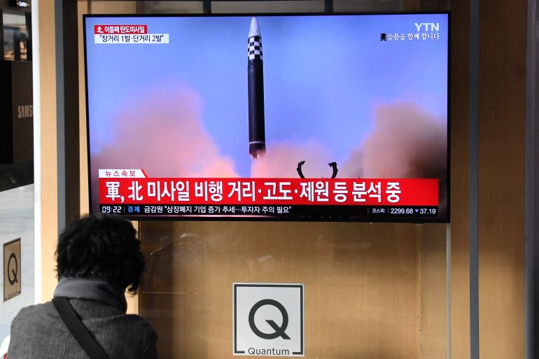 A woman watches a television screen showing a news broadcast with footage of a North Korean missile test, at a railway station in Seoul, South Korea, on November 3, 2022 [Jung Yeon-je/AFP]