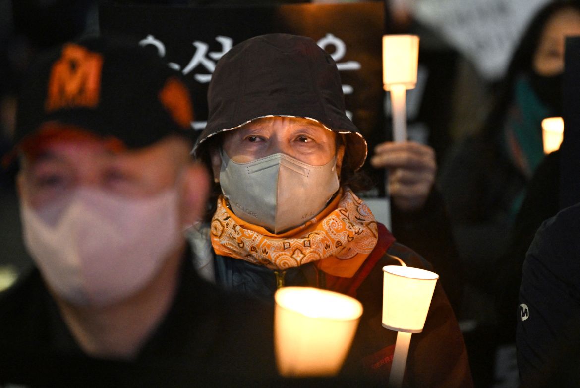 People take part in a candlelight vigil in Seoul.