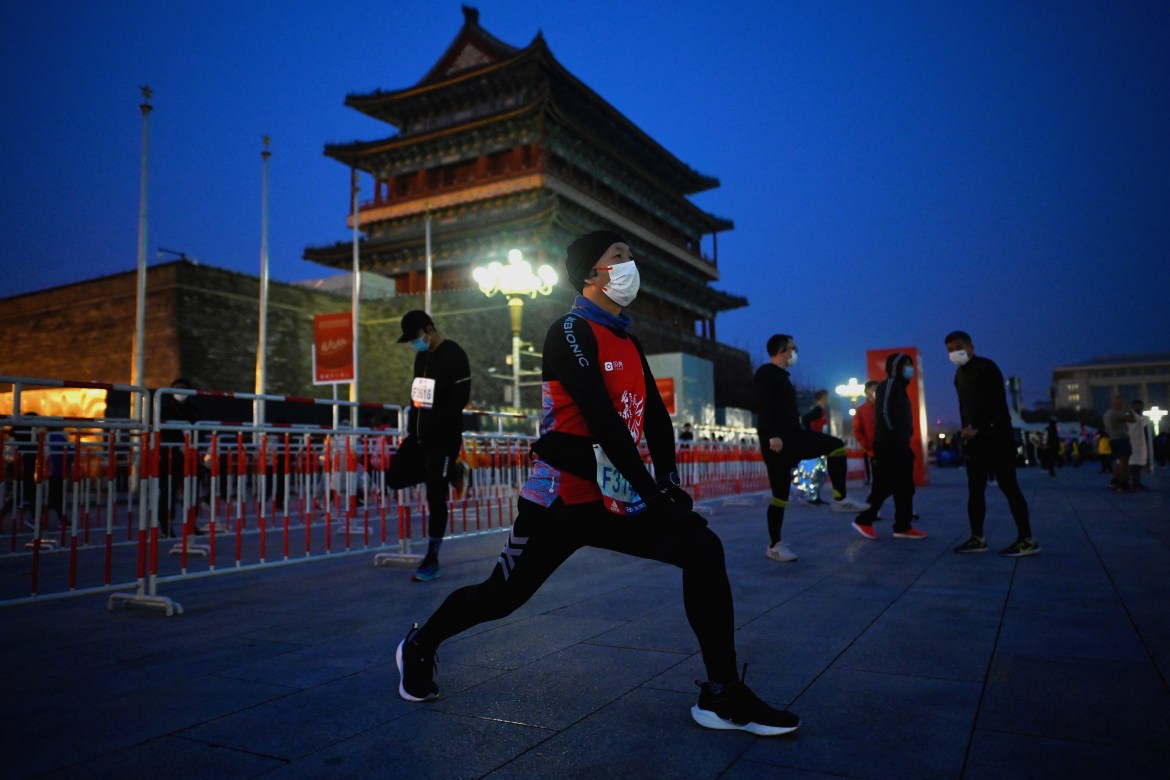 Participants prepare before the start of the Beijing Marathon.