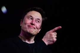 Musk smiling and pointing