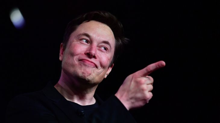 Musk smiling and pointing