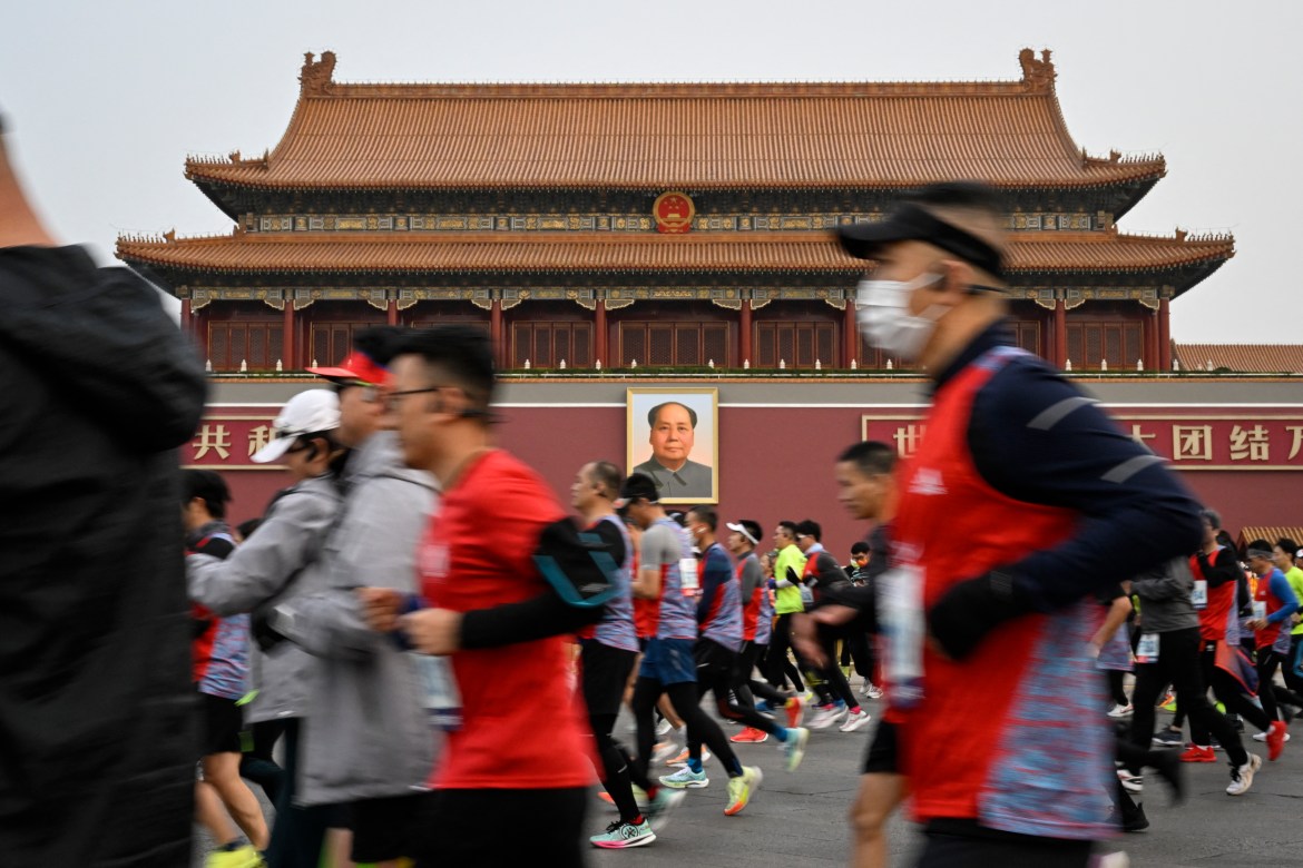 Participants run past Tiananmen Square during the Beijing Marathon.