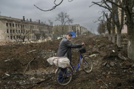 A man walks with his bicycle on the street of Siversk, a town in eastern Ukraine.