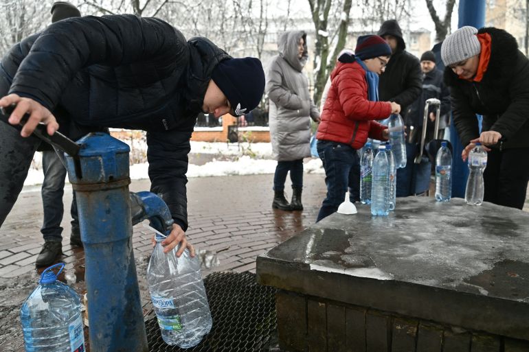 Kyiv residents fill plastic bottles at a water pump in a park in Kyiv.
