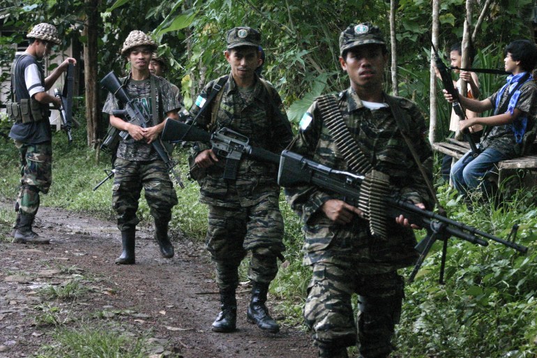 In this file photo, Moro Islamic Liberation Front (MILF) fighters patrol Ginanta village in southern Basilan island in 2007 [File: Mark Navales/AFP]