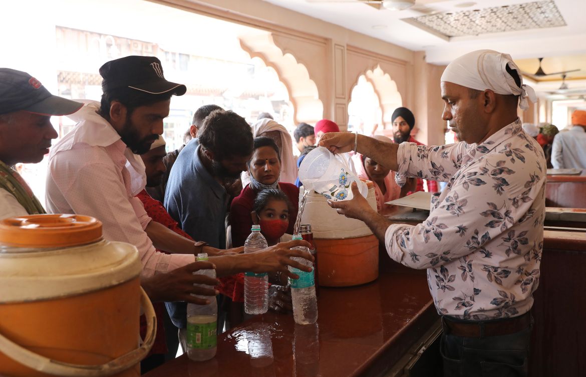 A volunteer distribute free drinking water