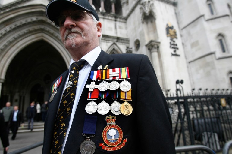 British nuclear test veteran Douglas Hern stands outside the High Court, in London