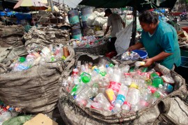 People sort through plastic bottles they collected at a junk shop in Manila [File: Reuters/Romeo Ranoco]