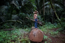 A child from the Uru-eu-wau-wau tribe, stands in an area deforested by invaders, after a meeting was called in the village of Alto Jamari to face the threat of armed land grabbers invading the Uru-eu-wau-wau Indigenous Reservation near Campo Novo de Rondonia, Brazil on January 30, 2019 [Ueslei Marcelino/Reuters]
