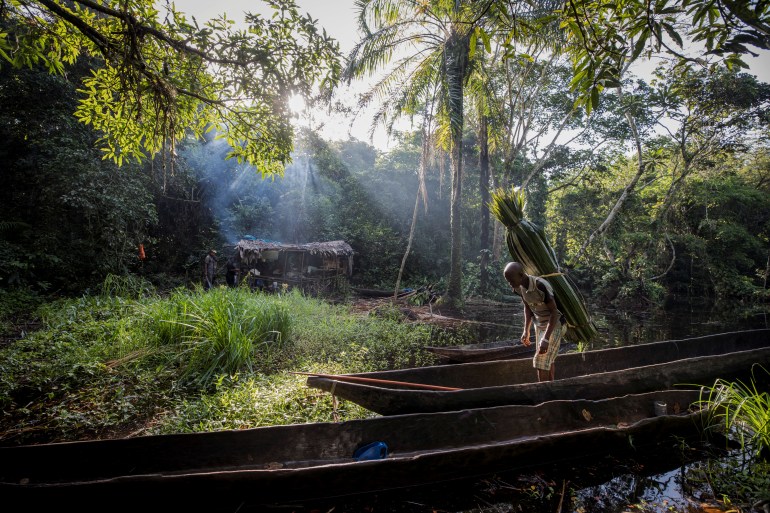 Mohamed Esimbo Matongu carries thatch, which he will use for the roof of his hut, back to his campsite which lies deep in the forest near the city of Mbandaka, Democratic Republic of the Congo, April 3, 2018. "When I was a teenager, I had to travel no more than 10 km upriver to find animals. But now I have to go as far as 40 km to come across a decent hunting ground," said Matongu. REUTERS/Thomas Nicolon SEARCH "BUSHMEAT NICOLON" FOR THIS STORY. SEARCH "WIDER IMAGE" FOR ALL STORIES. TPX IMAGES OF THE DAY.