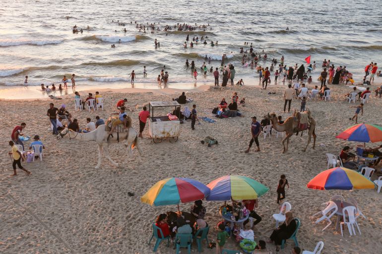 Palestinians spend time at a beach in Gaza July 8, 2021. Picture taken July 8, 2021. REUTERS/Ibraheem Abu Mustafa