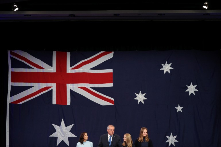 Scott Morrison with his family in front of a giant Australian flag