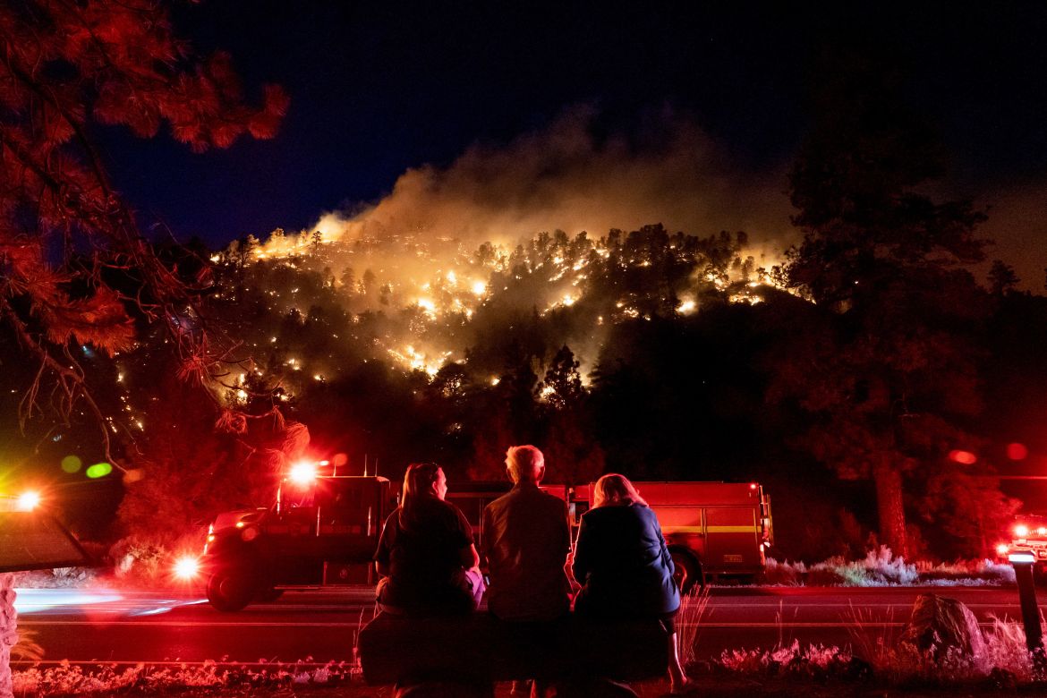 Residents watch part of the Sheep Fire wildfire