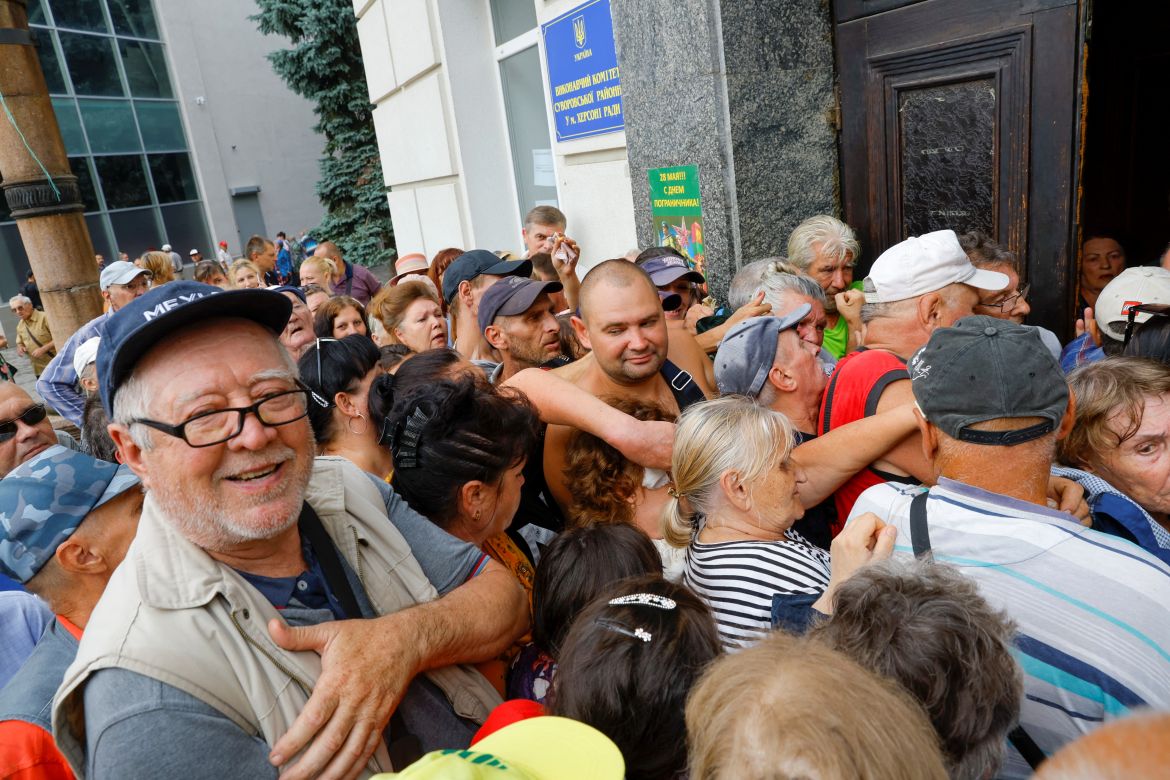 Local residents gather to receive financial aid during Ukraine-Russia conflict in the Russia-controlled city of Kherson