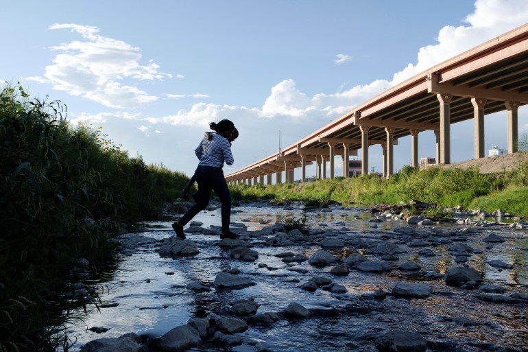 A Haitian asylum seeker crosses the Rio Grande river