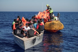 Crew members of NGO rescue ship &#39;Ocean Viking&#39; give lifejackets to refugees and migrants on an overcrowded boat in the Mediterranean Sea, October 25, 2022 [File: Camille Martin Juan/Sos Mediterranee/Handout via Reuters]