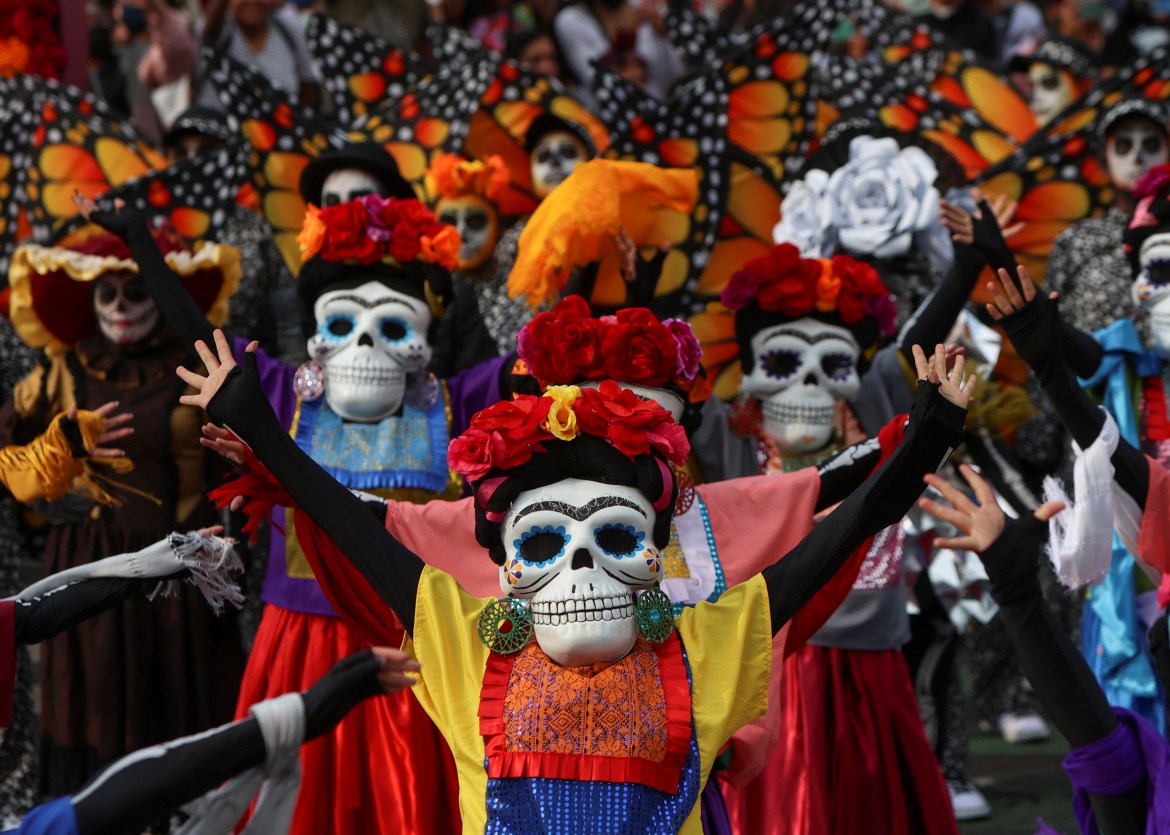 People take part in the Day of the Dead parade