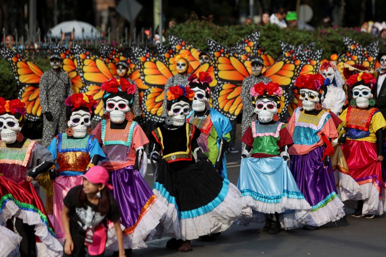 People take part in the Day of the Dead parade, in Mexico City