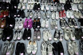Shoes belonging to victims are arranged at a gym.