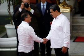 Colombia's Gustavo Petro shakes hands with Venezuela's Nicolas Maduro in Caracas
