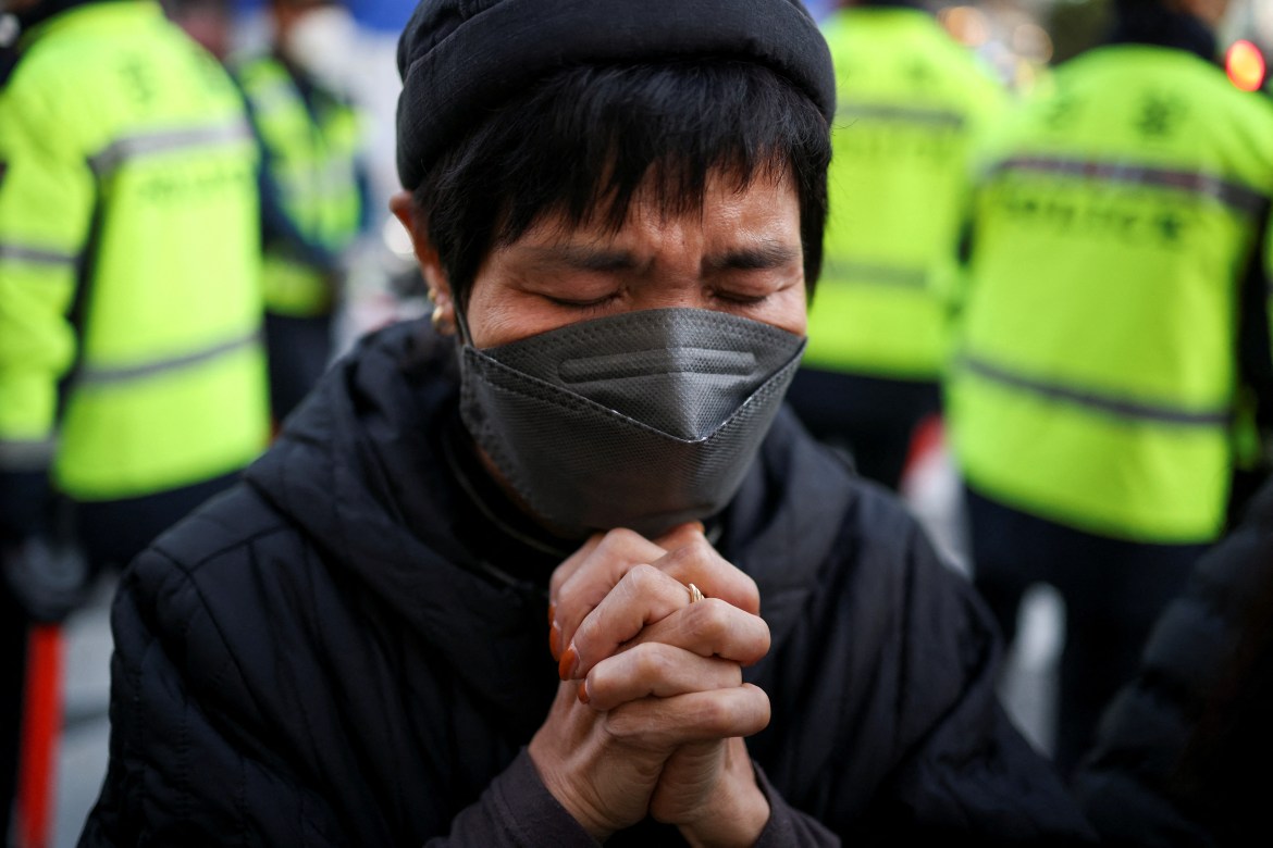 A mourner reacts near the site of a crowd crush.