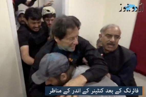 Former Pakistani Prime Minister Imran Khan is helped after he was shot in the shin in Wazirabad