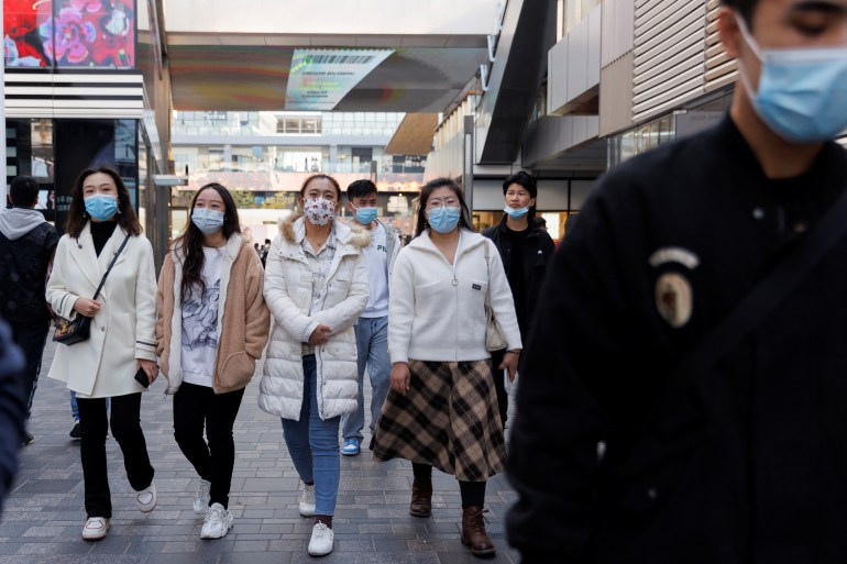 People wear masks in a shopping district as outbreaks of the coronavirus disease (COVID-19) continue in Beijing, China November 5, 2022