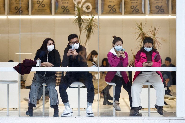 People wear masks at a coffeehouse as the outbreak of coronavirus disease (COVID-19) continues in Beijing, China November 5, 2022
