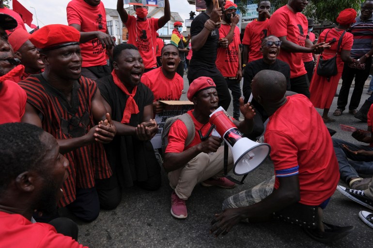 Ghanaians, dressed in red, march in the streets to protest worsening economic crisis and to call on the president to step down.