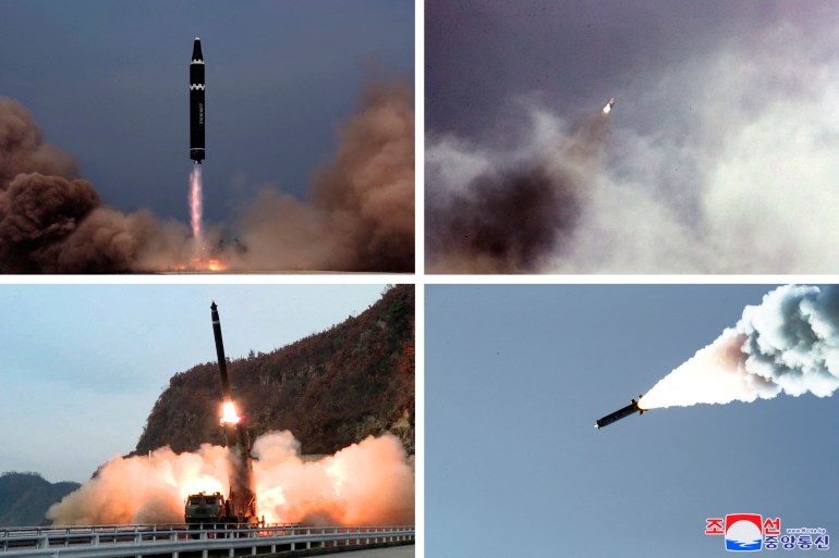 Composite picture showing four missile launches in North Korea including one black coloured missile with a horizontal white band heading directly into the air amid smoke, one travelling through the air right to left and one rising from a launcher amid smoke and flames.