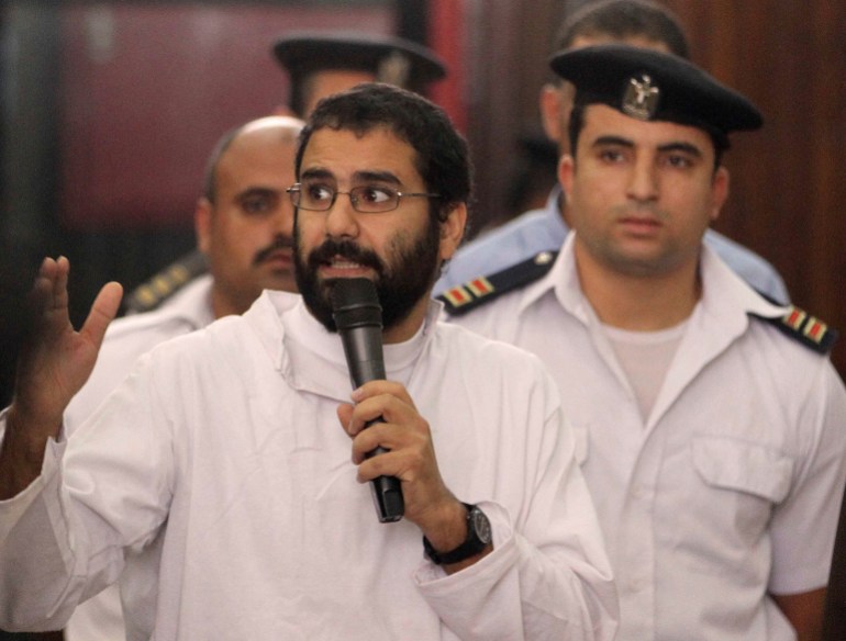 Activist Alaa Abd el-Fattah speaks in front of a judge at a court during his trial in Cairo, November 11, 2014.