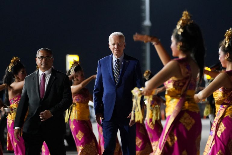 Joe Biden at the Bali airport being greeted by Balinese dancers.