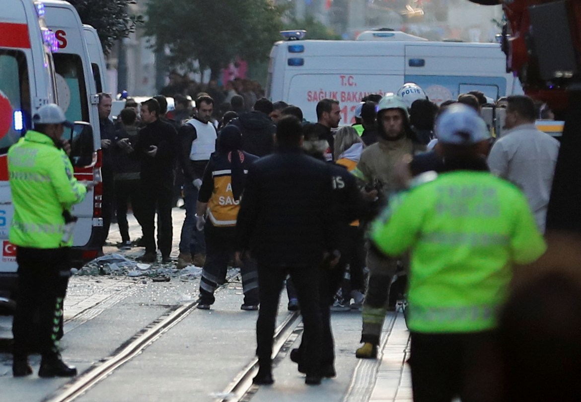 Police and emergency service members work at the scene after an explosion on busy pedestrian Istiklal street in Istanbul.
