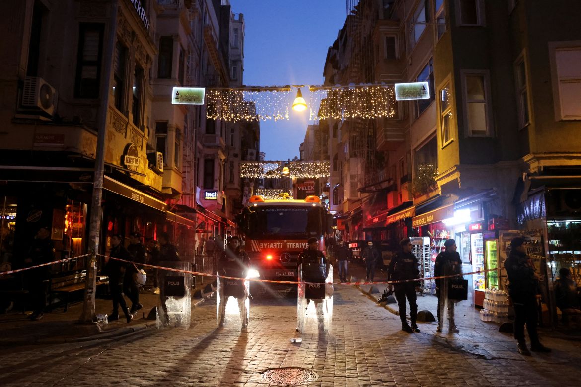 Members of the security forces stand near the scene after an explosion on busy pedestrian Istiklal street in Istanbul