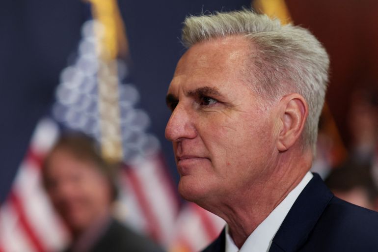 Profile of Kevin McCarthy with blurred US flag behind him