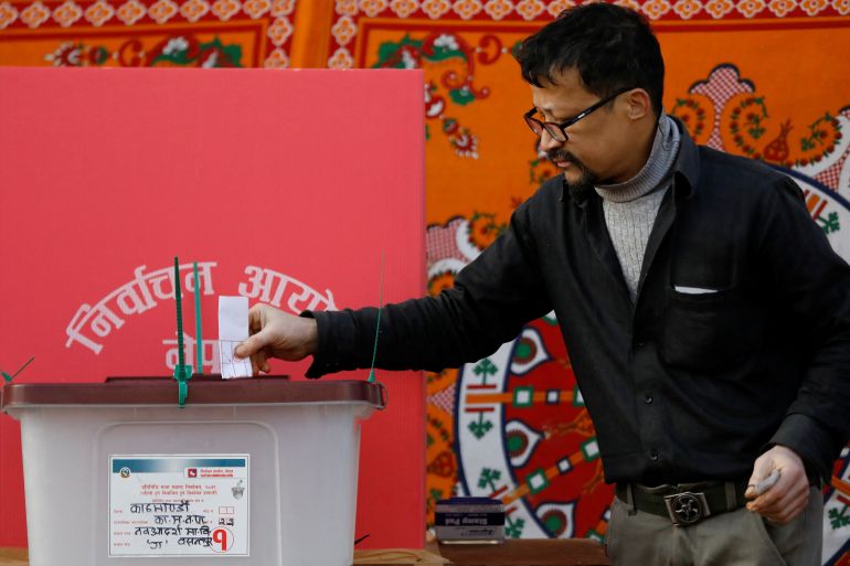 A man casts his vote during the general election, in Kathmandu, Nepal.