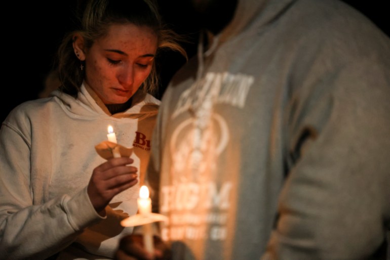 A woman holds a candle at a vigil after the Colorado mass shooting.