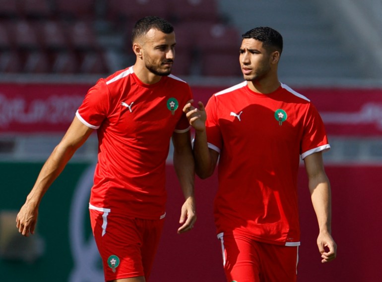 Morocco's Achraf Hakimi and Selim Amallah chat on the pitch during training at Al Duhail Stadium, in Doha, Qatar.