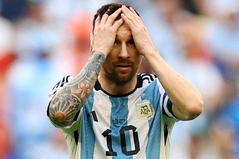 Argentina's Lionel Messi holds his head in his hands.