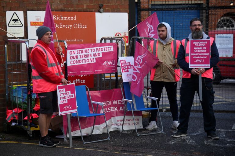Royal Mail workers strike outside of the Richmond Delivery Office in London