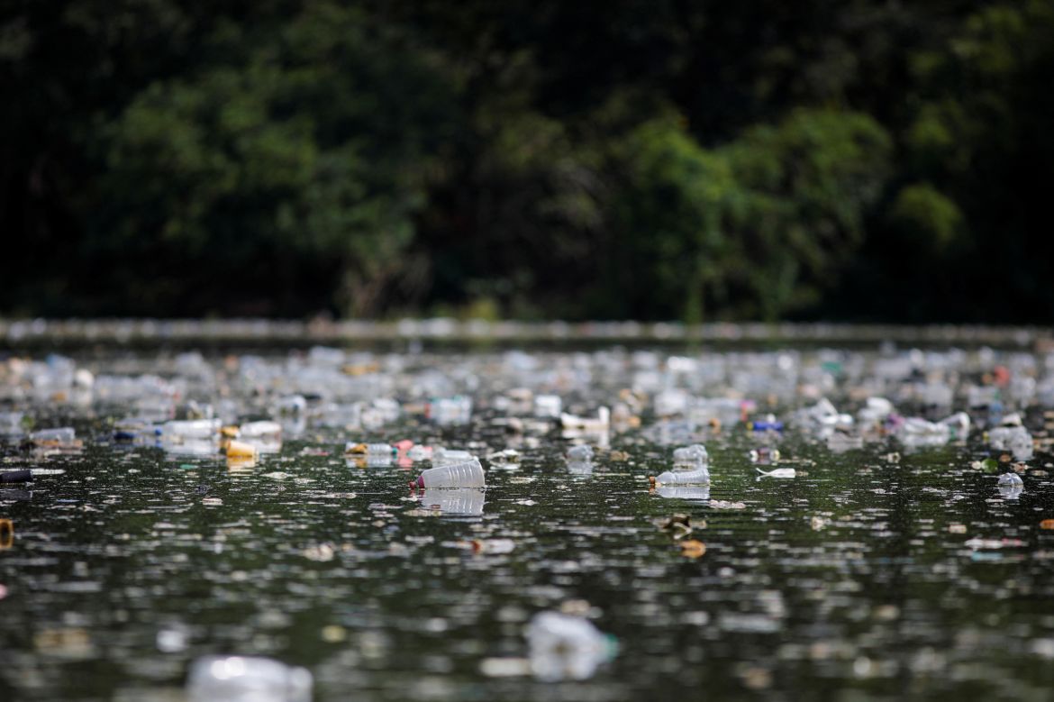 Plastic bottles float on the water of the El Cerron