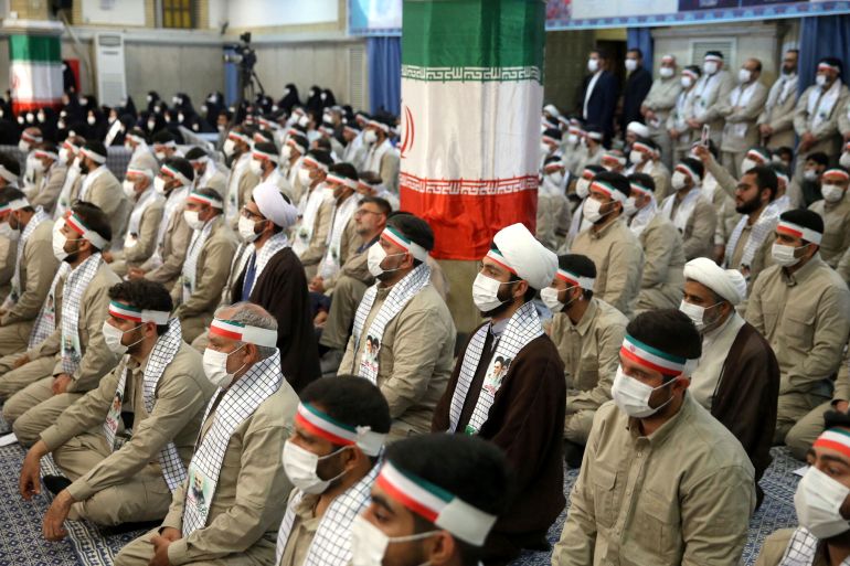 Iranian government supporters listening in a hall
